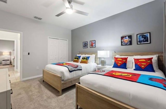 carpeted bedroom featuring a closet and ceiling fan