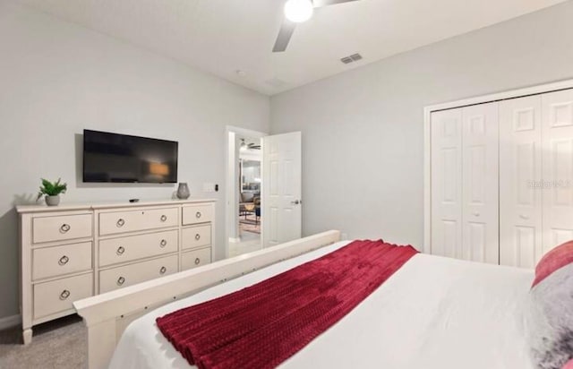 bedroom with light carpet, a closet, and ceiling fan