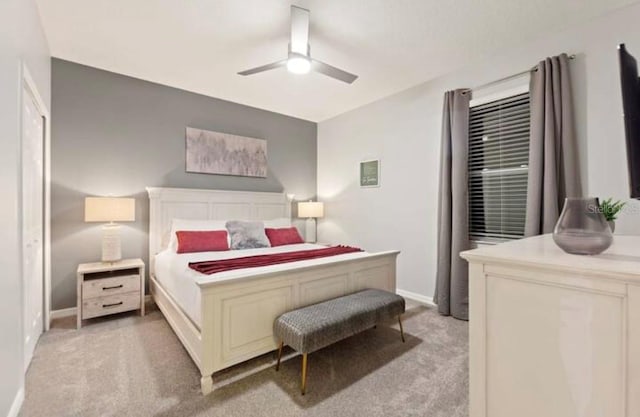 bedroom featuring light colored carpet and ceiling fan