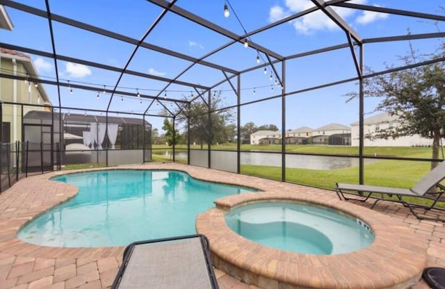 view of swimming pool with an in ground hot tub, a patio, a water view, and a lanai