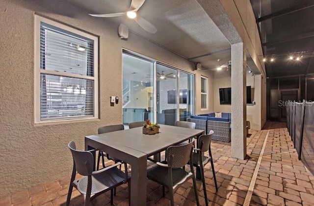 dining area with ceiling fan and a textured ceiling