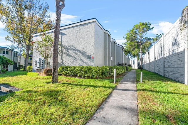 view of side of home with a lawn