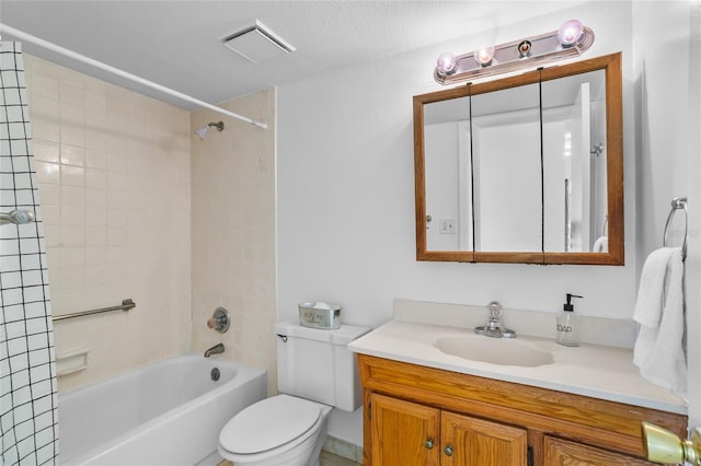 full bathroom with tiled shower / bath combo, toilet, a textured ceiling, and vanity