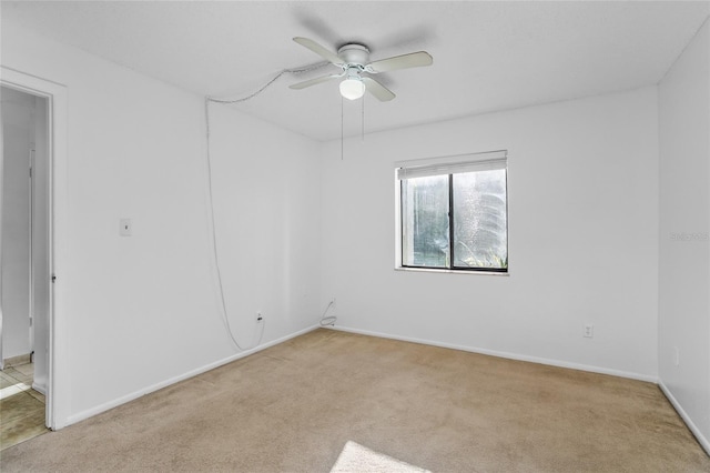 empty room featuring light carpet and ceiling fan