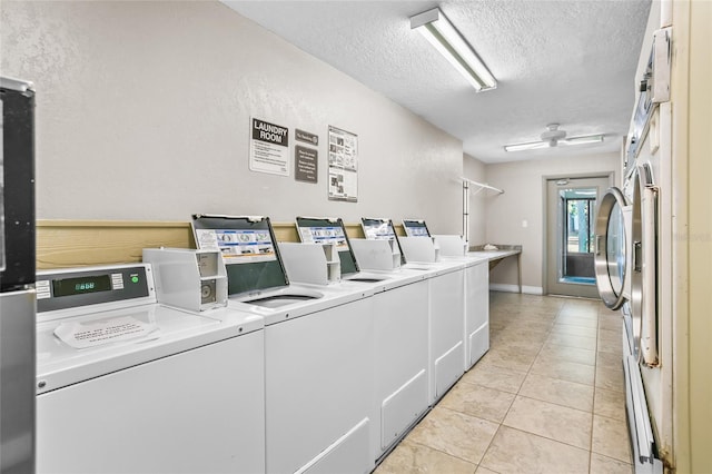 clothes washing area featuring ceiling fan, independent washer and dryer, a textured ceiling, and light tile patterned floors