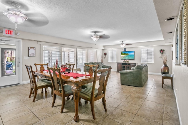 dining room with a textured ceiling, ceiling fan, and light tile patterned flooring