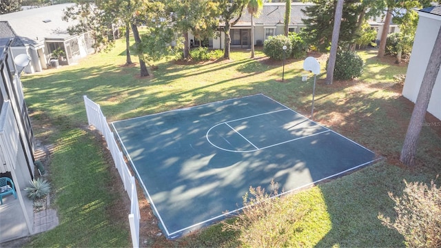 view of sport court with a lawn