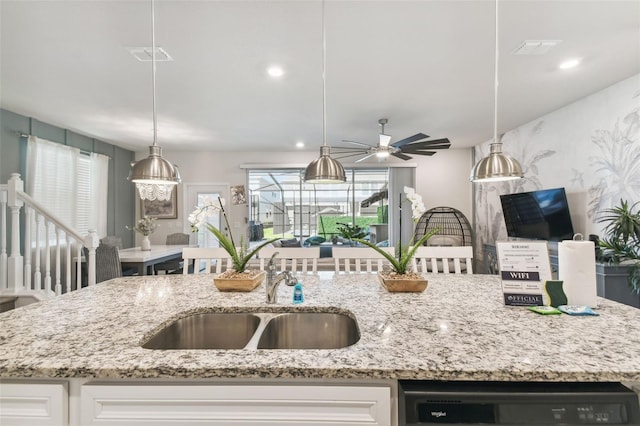 kitchen featuring white cabinets, black dishwasher, ceiling fan, and sink