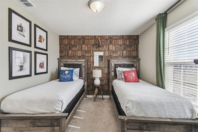 bedroom with carpet flooring and a textured ceiling