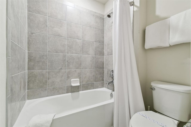 bathroom featuring shower / bath combination with curtain and toilet