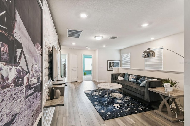 living room featuring hardwood / wood-style floors and a textured ceiling