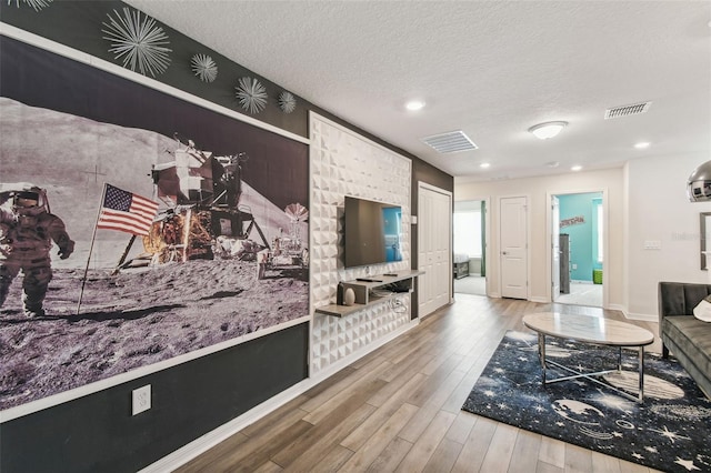 living room featuring hardwood / wood-style floors and a textured ceiling