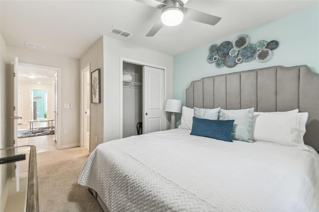 bedroom with ceiling fan, a closet, and light carpet