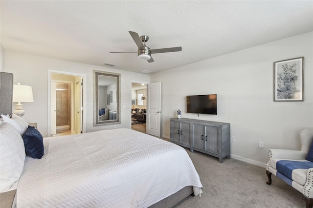 carpeted bedroom featuring ceiling fan and ensuite bathroom