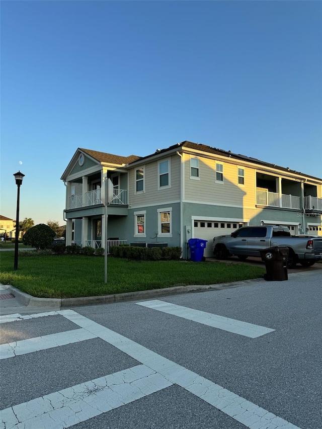 view of front of house featuring a garage and a front lawn