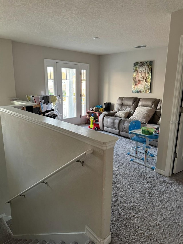 carpeted living room with a textured ceiling