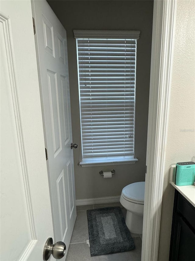 bathroom featuring tile patterned flooring, vanity, and toilet