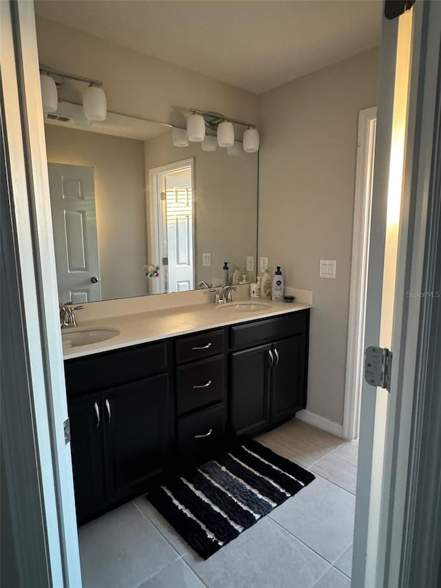 bathroom featuring tile patterned flooring and vanity