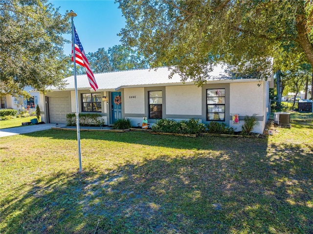 single story home with a garage, a front lawn, and central air condition unit