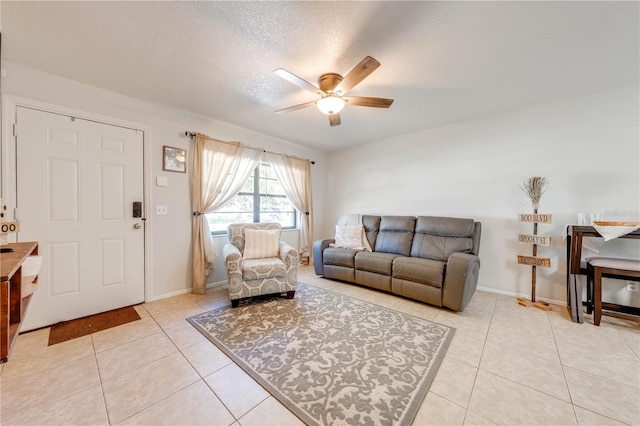 tiled living room with ceiling fan and a textured ceiling