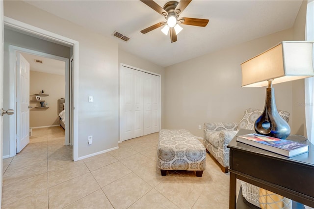 living area featuring ceiling fan and light tile patterned floors