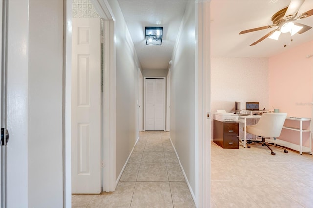 hall featuring light tile patterned floors