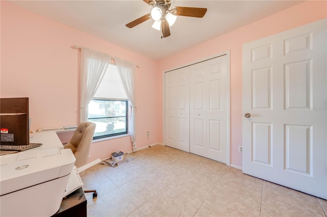 office area with light tile patterned floors and ceiling fan