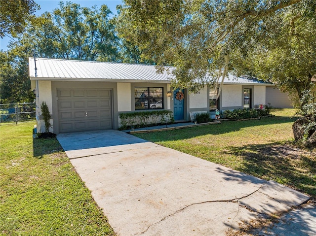 ranch-style house with a garage and a front lawn