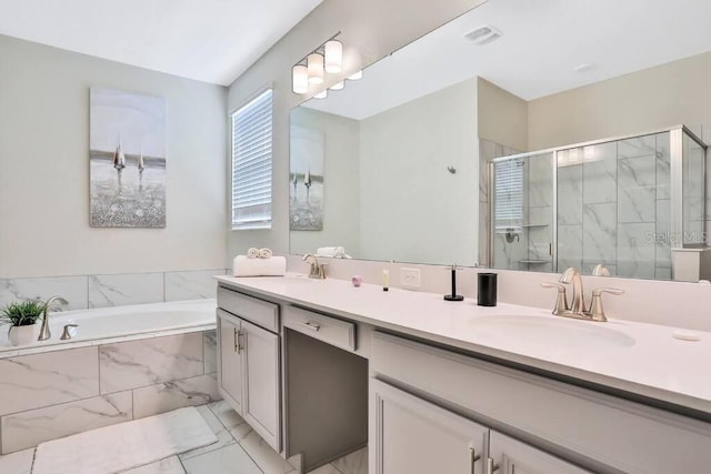 8932 Cabot Cliffs Dr, Davenport, FL 33896 - bathroom featuring double vanity, a garden tub, a shower stall, and marble finish flooring