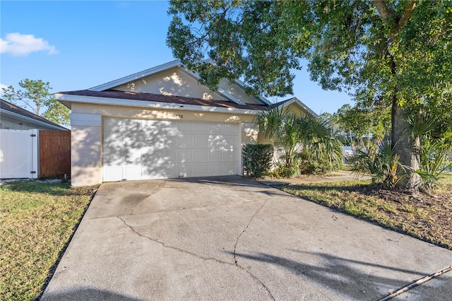 single story home featuring a garage and a front lawn