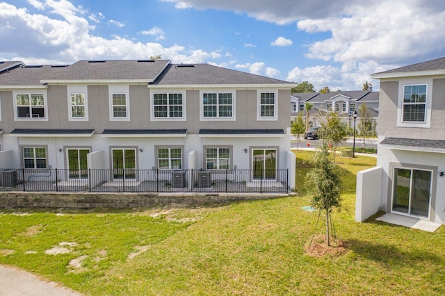 rear view of property featuring a yard