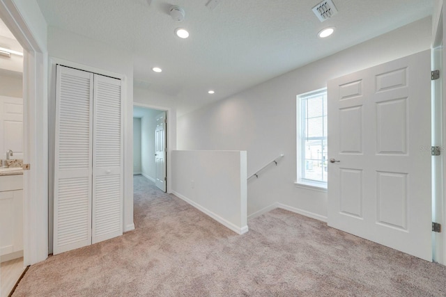 carpeted foyer entrance featuring sink