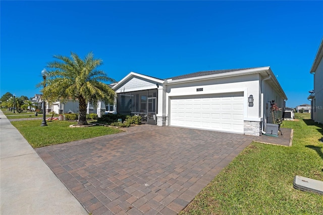 ranch-style home with a garage, a front lawn, and a sunroom