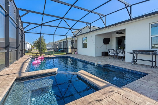 view of pool featuring glass enclosure, ceiling fan, and a patio