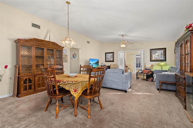 5846 Greenbriar Ct, Zephyrhills, FL 33542 - carpeted dining room featuring a chandelier, lofted ceiling, and ceiling fan