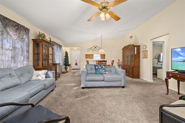 5846 Greenbriar Ct, Zephyrhills, FL 33542 - carpeted living area with ceiling fan, vaulted ceiling, and plenty of natural light