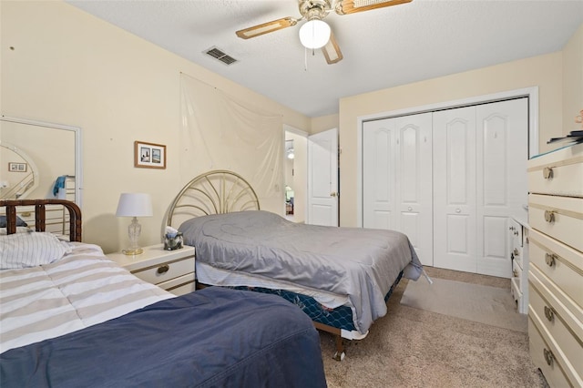 5846 Greenbriar Ct, Zephyrhills, FL 33542 - carpeted bedroom with a closet, a ceiling fan, and a textured ceiling