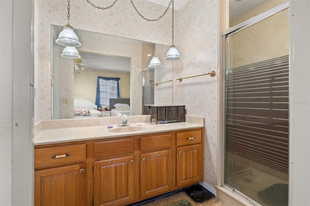 5846 Greenbriar Ct, Zephyrhills, FL 33542 - ensuite bathroom featuring wallpapered walls, vanity, and a shower stall