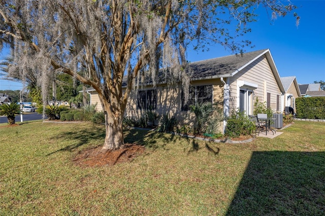 5846 Greenbriar Ct, Zephyrhills, FL 33542 - view of property exterior with a lawn and a central air condition unit