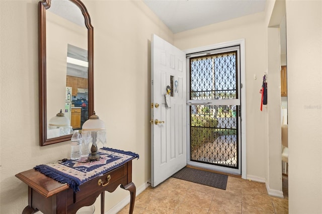 5846 Greenbriar Ct, Zephyrhills, FL 33542 - foyer with baseboards and light tile patterned floors
