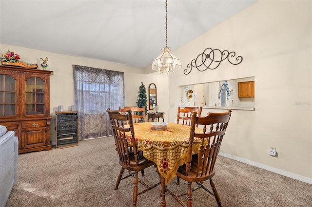 dining room featuring carpet and an inviting chandelier