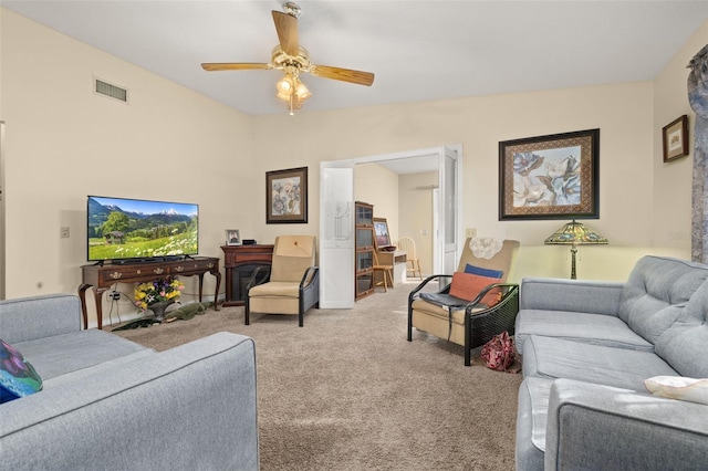 carpeted living room with vaulted ceiling and ceiling fan