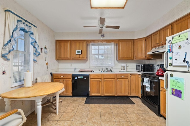 5846 Greenbriar Ct, Zephyrhills, FL 33542 - kitchen featuring black appliances, wallpapered walls, under cabinet range hood, light countertops, and brown cabinetry