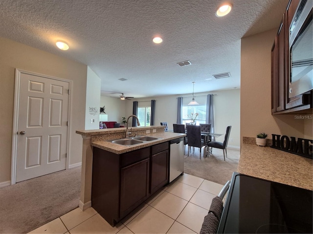 kitchen featuring dark brown cabinets, sink, light carpet, and stainless steel appliances