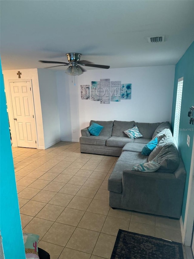 tiled living room with ceiling fan