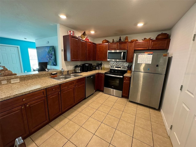 kitchen with light tile patterned flooring, stainless steel appliances, and sink