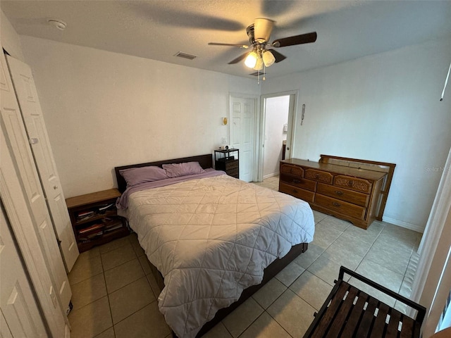 tiled bedroom with ceiling fan