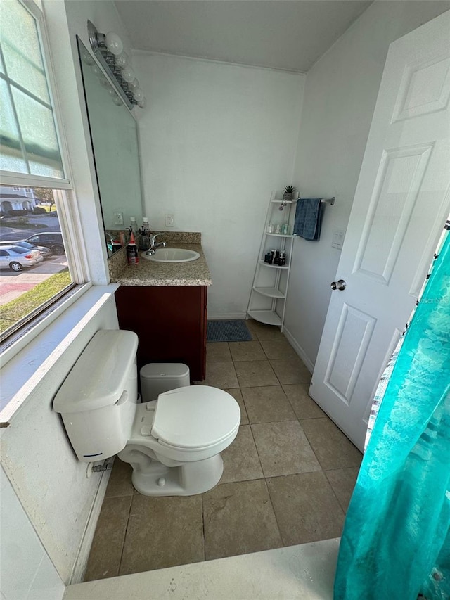 bathroom with tile patterned floors, vanity, and toilet