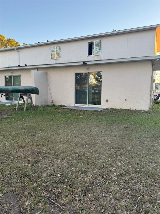 rear view of house with a yard