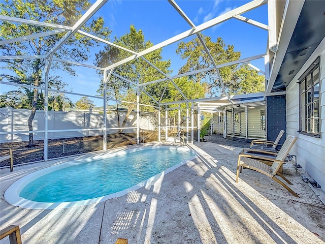 view of swimming pool with a lanai, a fenced backyard, a fenced in pool, and a patio